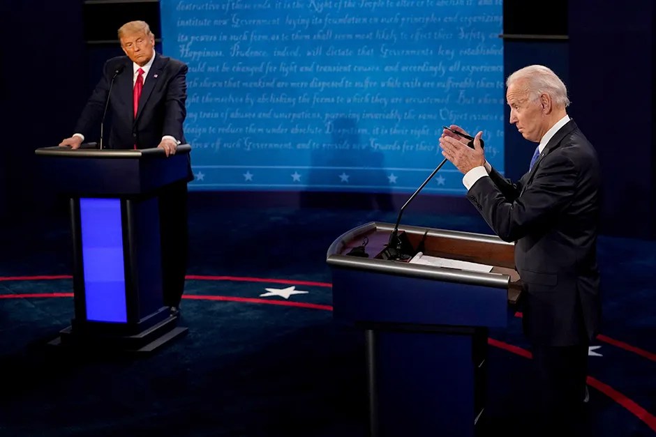 Joe Biden answers a question as Donald Trump listens during the second and final 2020 presidential debate.