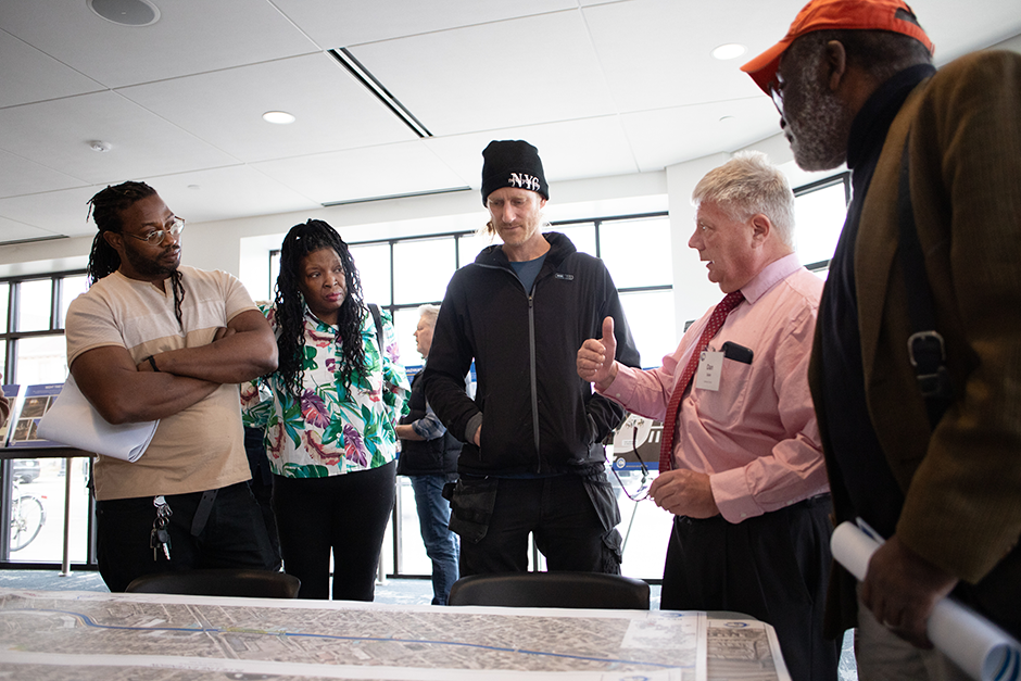 From left, Jon McGlory, Davrashawn Johnson, Brian Canfield, and Andrew McGlory talk with Hennepin County Director Of Transit and Mobility Dan Soler, second from right, about their buildings being potentially demolished for Blue Line Extension construction.