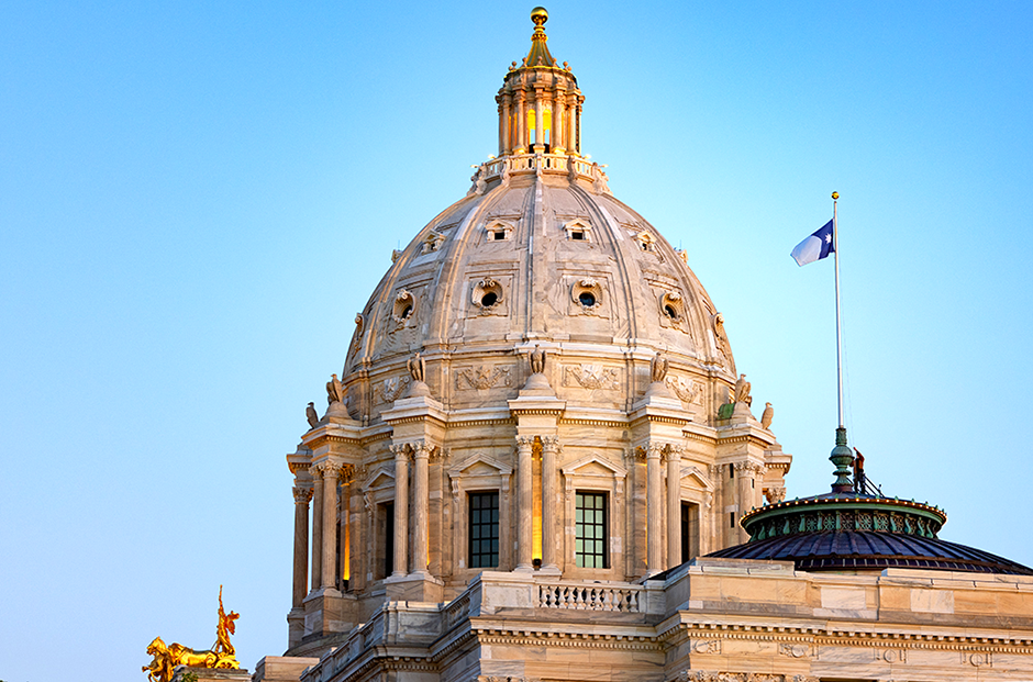 Charlie Krueger, a Facilities Management worker, raising Minnesota’s new state flag on May 11 over the east wing of the Minnesota State Capitol.