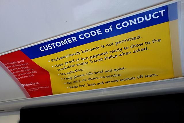 A Metro Transit code of conduct sign displayed on a Green Line train.