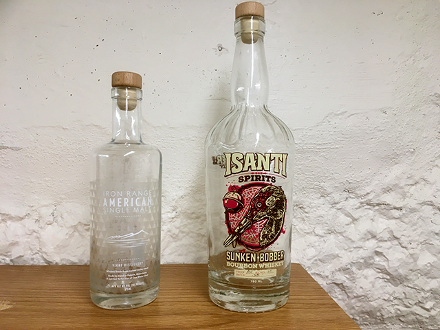 The state’s craft distilleries can’t sell standard-size bottles, right, but relegated instead to selling “novelty” .375 liter bottles, left.
