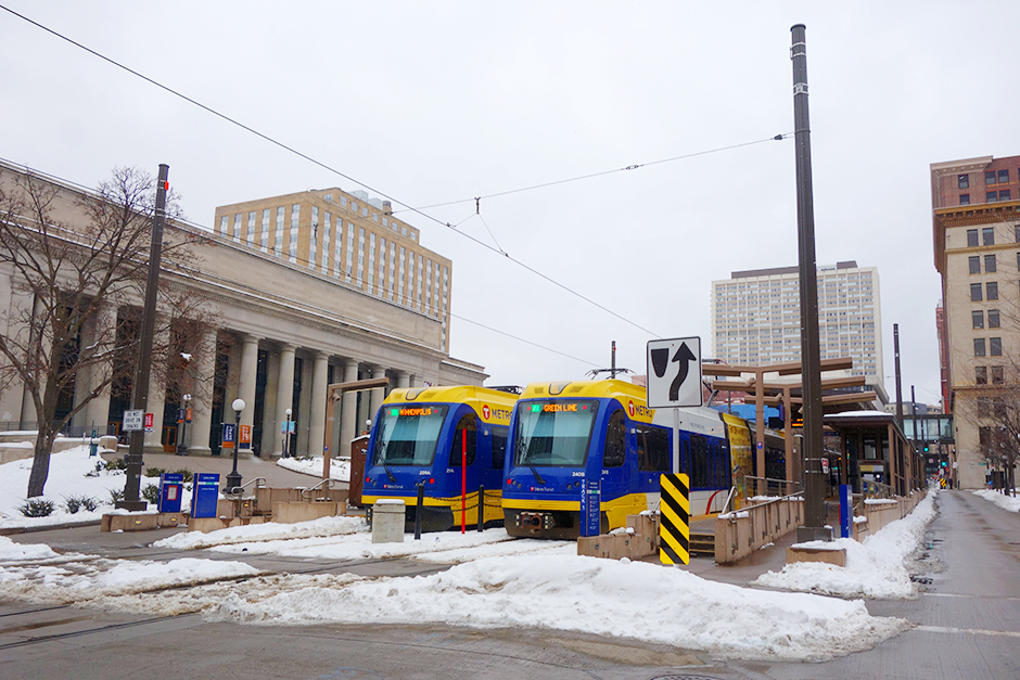 Green Line trains in front of the St. Paul Depot