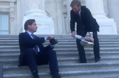 screenshot of video of dean phillips and peter meijer exchanging a shoe