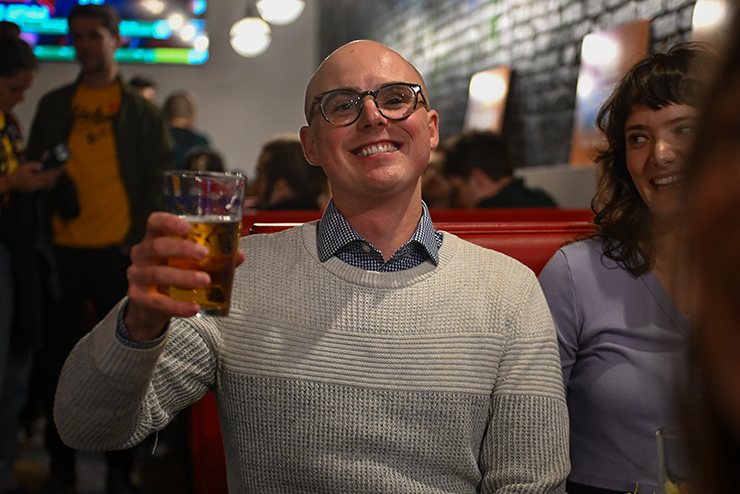 Minneapolis Ward 8 candidate Soren Stevenson hoisting a beer at his election night gathering at Los Andes Latin Bistro.