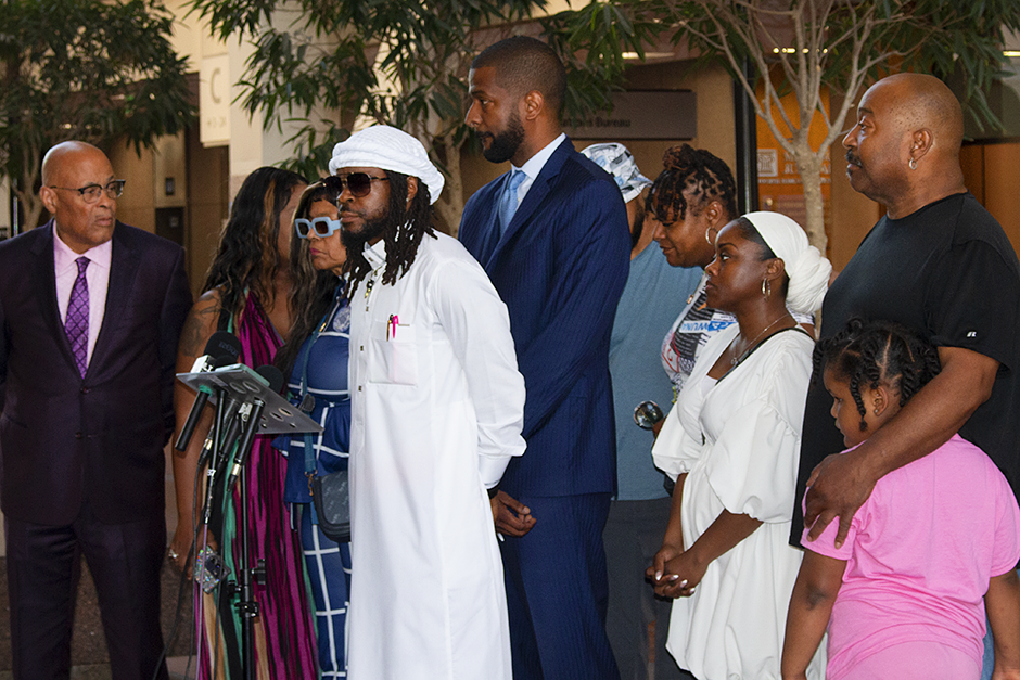 Members of Ricky Cobb II’s family and legal team, including his mother, Nyra Fields-Miller (in sunglasses), twin brother Rashad Cobb (in white) and Bakari Sellers, the family’s attorney (blue suit) at Tuesday’s press conference at the Hennepin County Government Center.